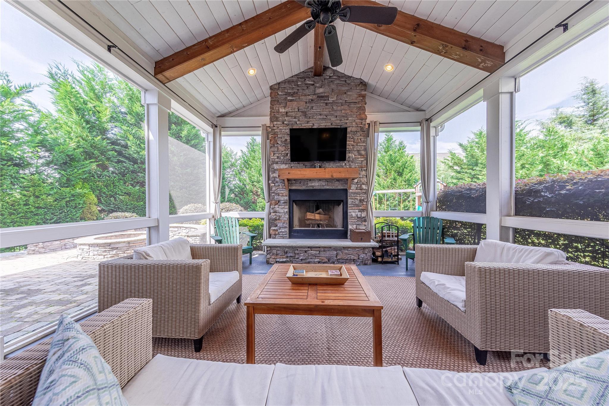 5256 Meadowcroft Way Fort Mill, SC 29708 - Photo 42 of 48 a living room with furniture a large window and a fireplace