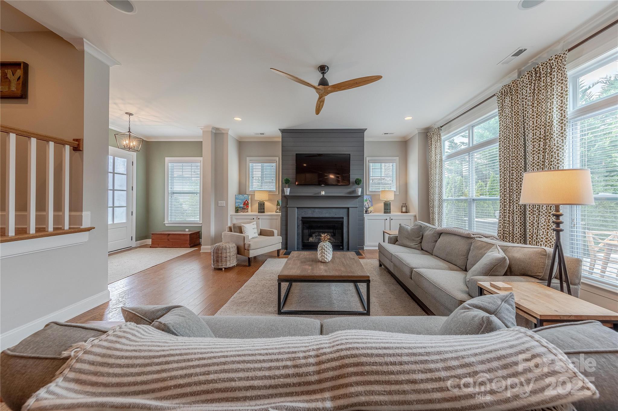 5256 Meadowcroft Way Fort Mill, SC 29708 - Photo 7 of 48 a living room with furniture a fireplace and a flat screen tv