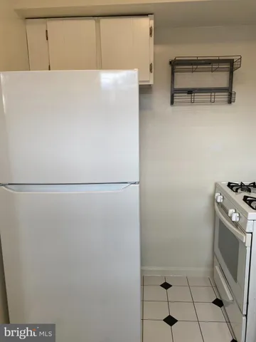 a stove top oven sitting inside of a kitchen