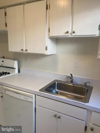 a kitchen with a sink cabinets and window