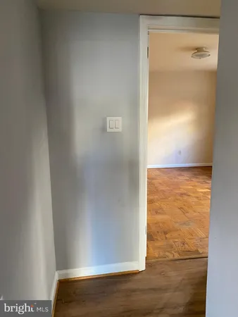 a view of an empty room and wooden floor