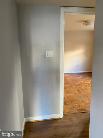 a view of an empty room and wooden floor