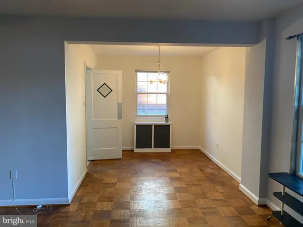 an empty room with windows and entrance