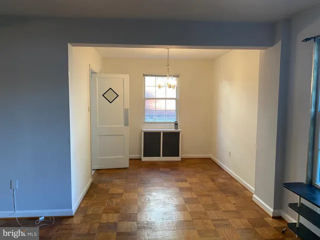 an empty room with windows and entrance