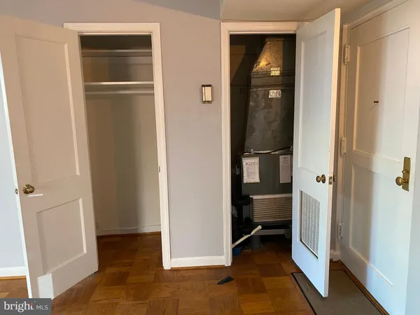 a view of a kitchen with stove and white cabinets