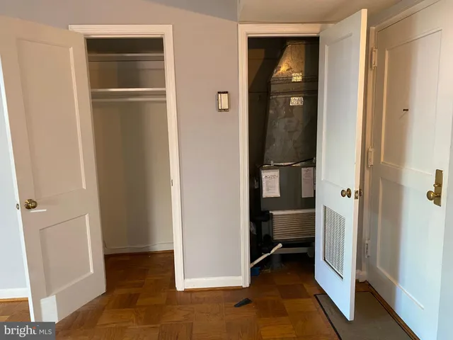 a view of a kitchen with stove and white cabinets