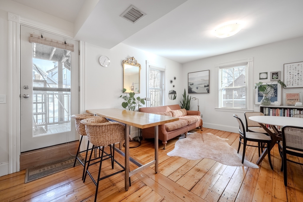 20 Porter Street, Unit 2 Boston, MA 02130 - Photo 13 of 35 a view of a dining room with furniture and wooden floor