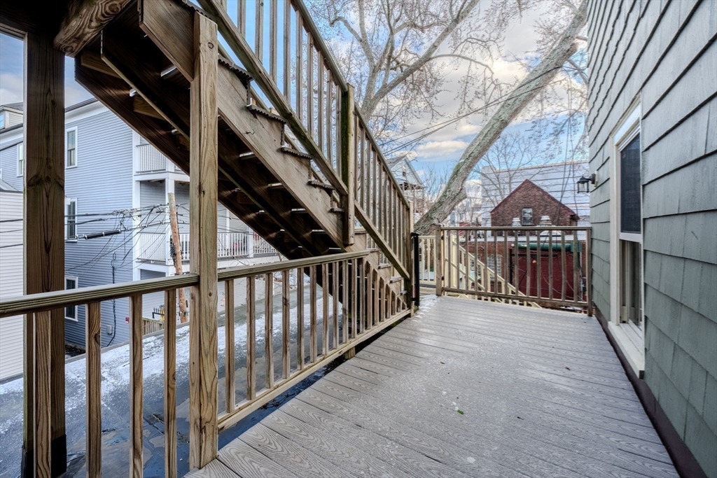 20 Porter Street, Unit 2 Boston, MA 02130 - Photo 17 of 35 a view of staircase with wooden floor and fence