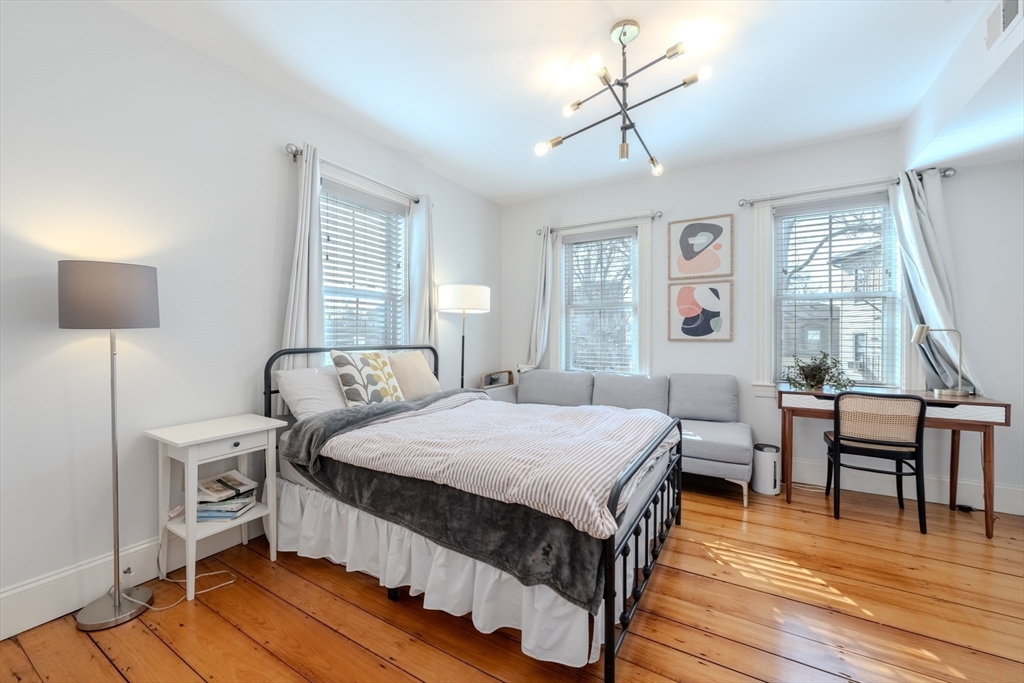 20 Porter Street, Unit 2 Boston, MA 02130 - Photo 23 of 35 a bedroom with a bed a table and three windows