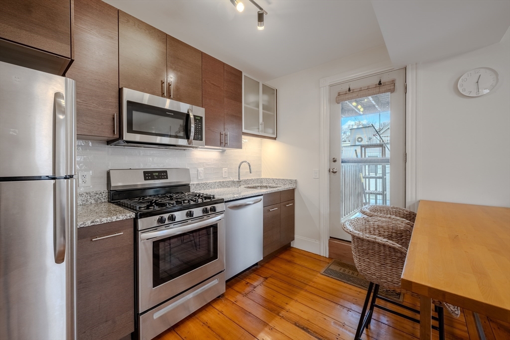 20 Porter Street, Unit 2 Boston, MA 02130 - Photo 3 of 35 a kitchen with stainless steel appliances a stove a microwave and a refrigerator