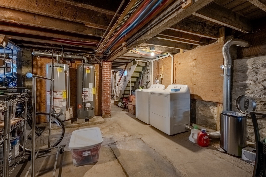 20 Porter Street, Unit 2 Boston, MA 02130 - Photo 31 of 35 a view of a storage room with water heater and racks