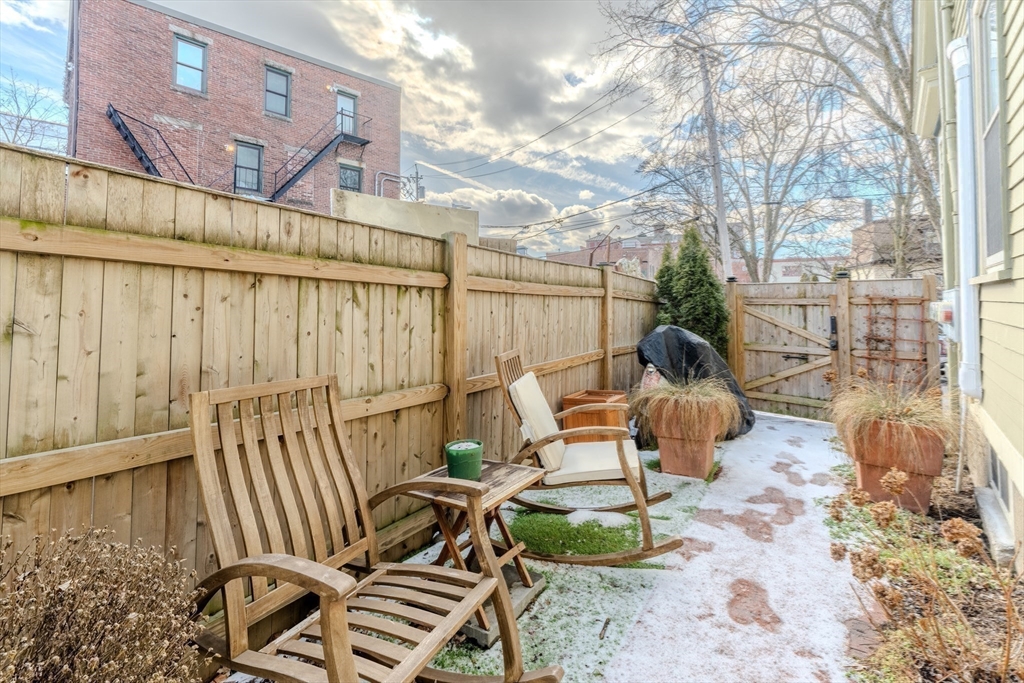 20 Porter Street, Unit 2 Boston, MA 02130 - Photo 34 of 35 a backyard of a house with table and chairs