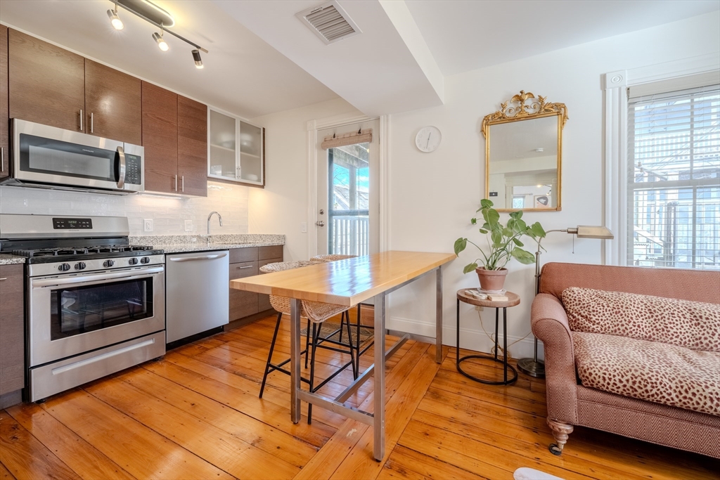 20 Porter Street, Unit 2 Boston, MA 02130 - Photo 6 of 35 a kitchen with stainless steel appliances a stove a table and chairs