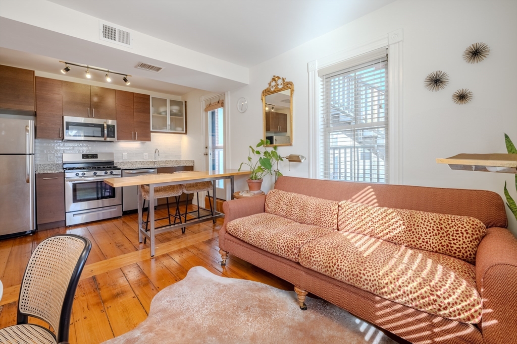 20 Porter Street, Unit 2 Boston, MA 02130 - Photo 7 of 35 a living room with furniture fireplace and a large window
