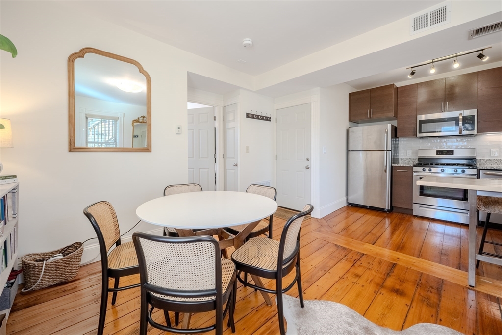 20 Porter Street, Unit 2 Boston, MA 02130 - Photo 10 of 35 a view of a dining room with furniture and wooden floor