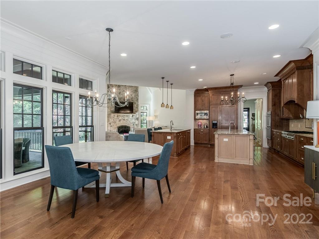 14140 Claysparrow Road Charlotte, NC 28278 - Photo 13 of 48 a large kitchen with kitchen island a dining table and chairs