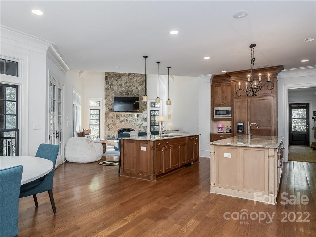 14140 Claysparrow Road Charlotte, NC 28278 - Photo 14 of 48 a large living room with stainless steel appliances granite countertop furniture a fireplace a rug and a large window