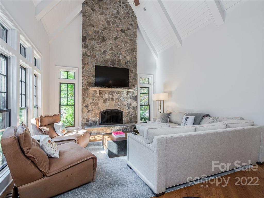 14140 Claysparrow Road Charlotte, NC 28278 - Photo 16 of 48 a living room with furniture a fireplace and a flat screen tv