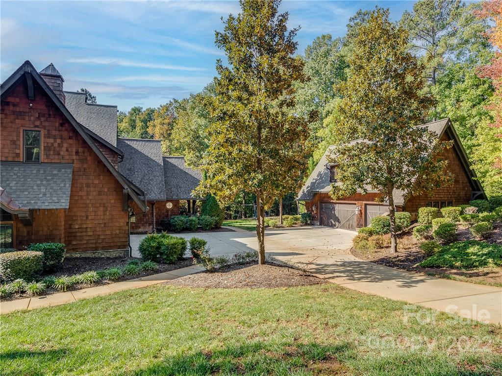 14140 Claysparrow Road Charlotte, NC 28278 - Photo 3 of 48 a front view of a house with a yard and garage
