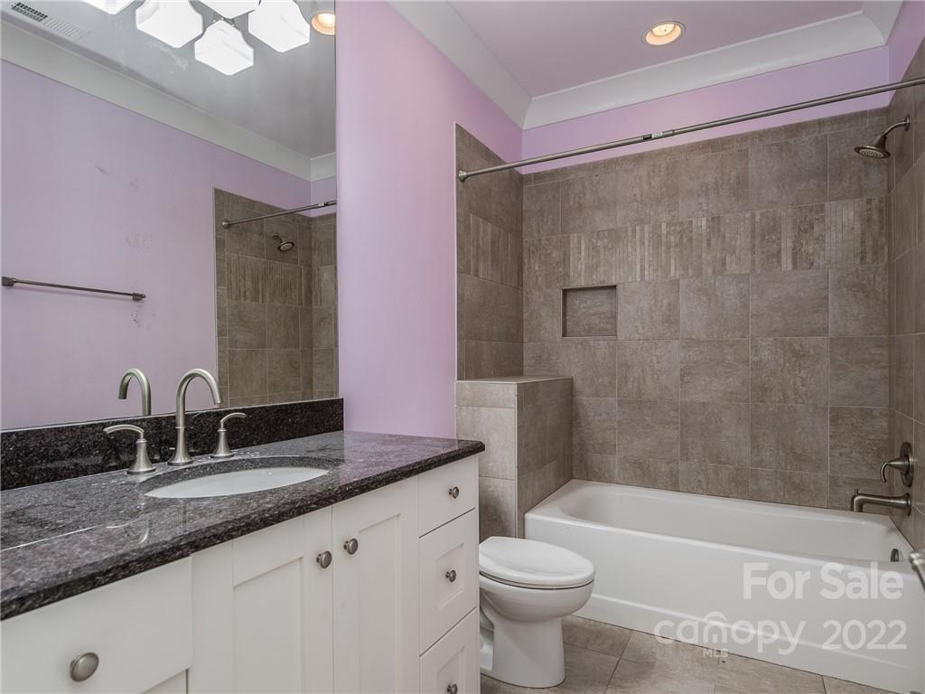 14140 Claysparrow Road Charlotte, NC 28278 - Photo 31 of 48 a bathroom with a granite countertop bathtub shower sink vanity mirror and toilet