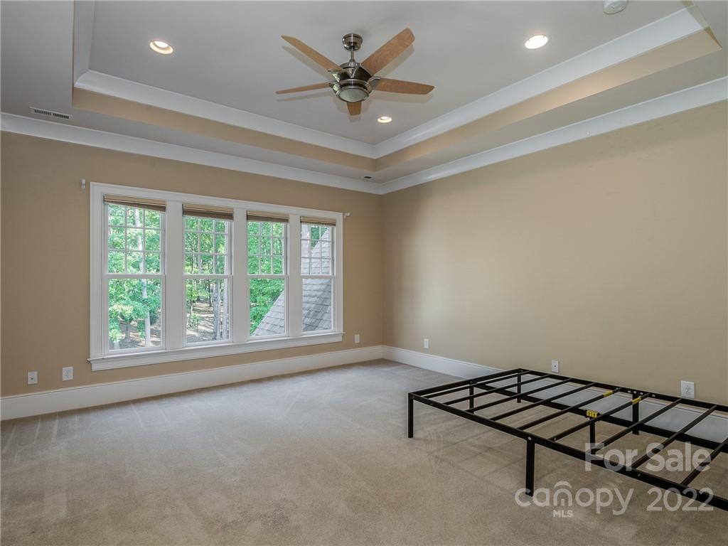 14140 Claysparrow Road Charlotte, NC 28278 - Photo 32 of 48 an empty room with windows and ceiling fan
