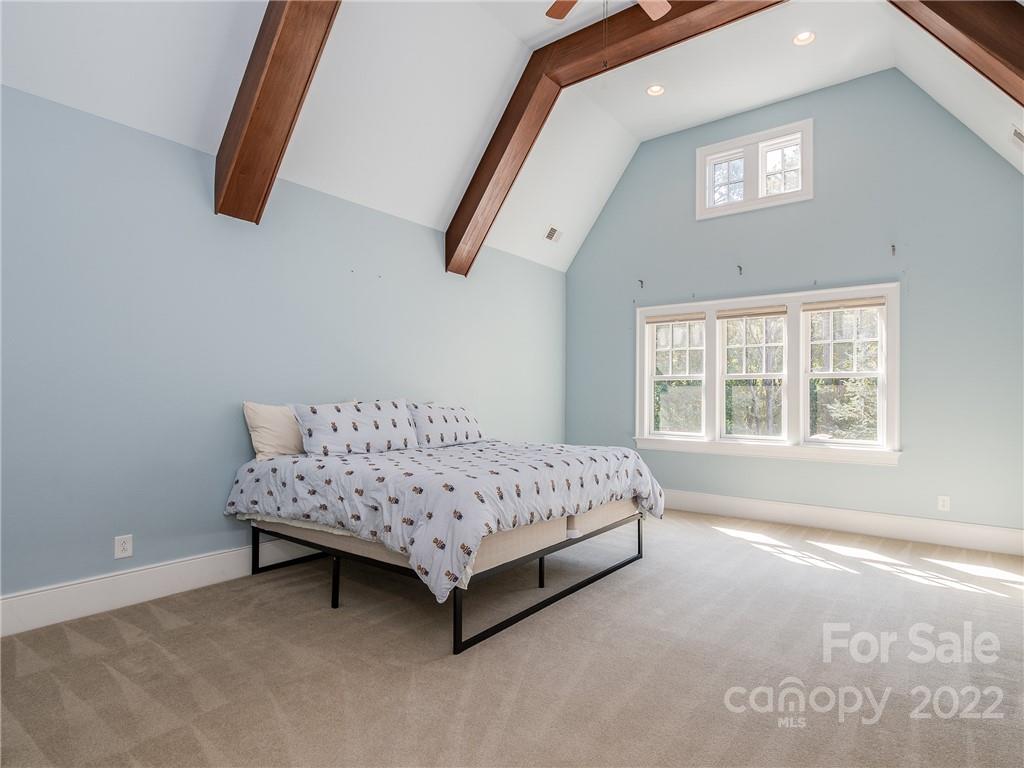 14140 Claysparrow Road Charlotte, NC 28278 - Photo 33 of 48 a spacious bedroom with a bed and a window