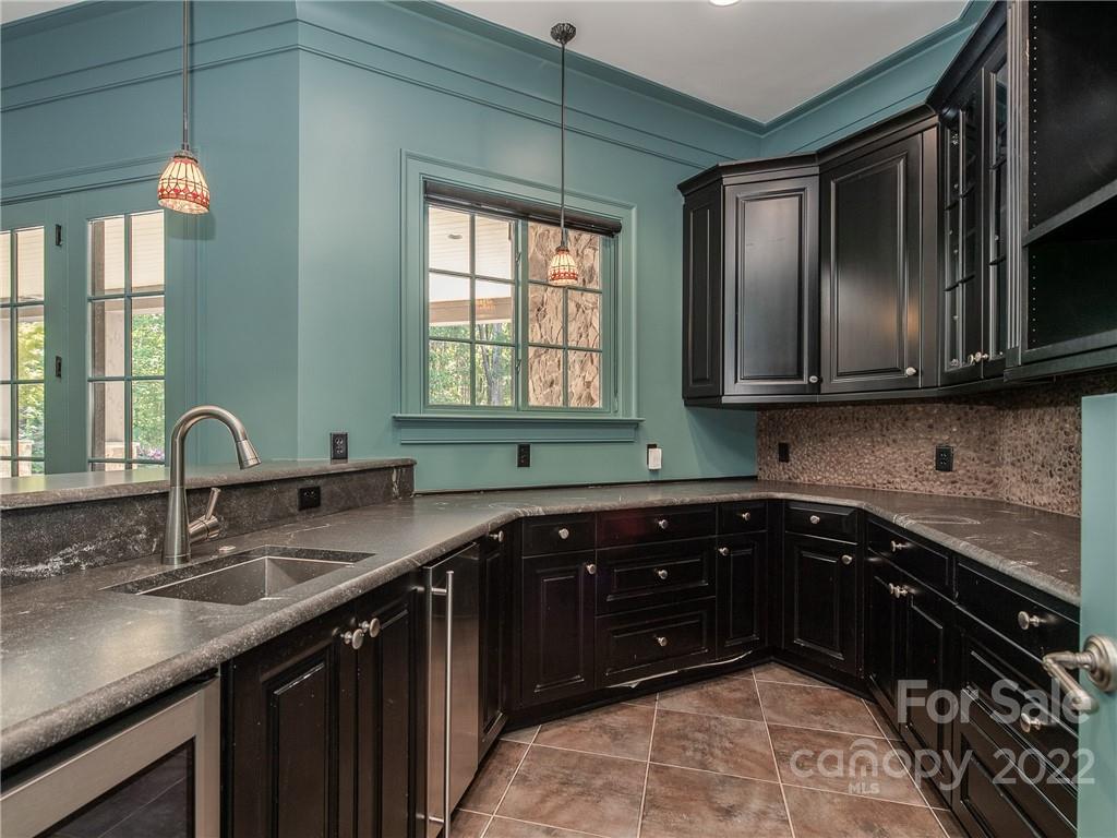 14140 Claysparrow Road Charlotte, NC 28278 - Photo 38 of 48 a kitchen with stainless steel appliances granite countertop a sink stove and cabinets