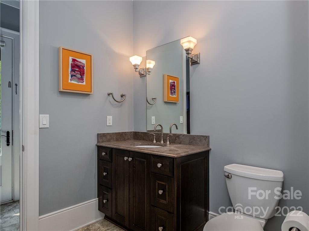 14140 Claysparrow Road Charlotte, NC 28278 - Photo 44 of 48 a bathroom with a toilet a sink and mirror
