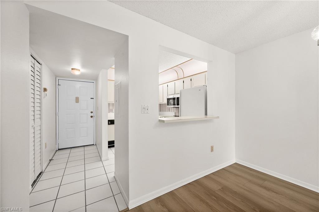 4251 27th Court Southwest, Unit 104 Naples, FL 34116 - Photo 3 of 22 a view of a hallway with wooden floor