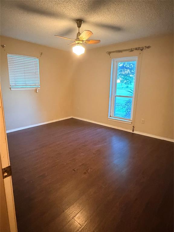 3472 North Masch Branch Road Denton, TX 76249 - Photo 15 of 17 an empty room with wooden floor and windows