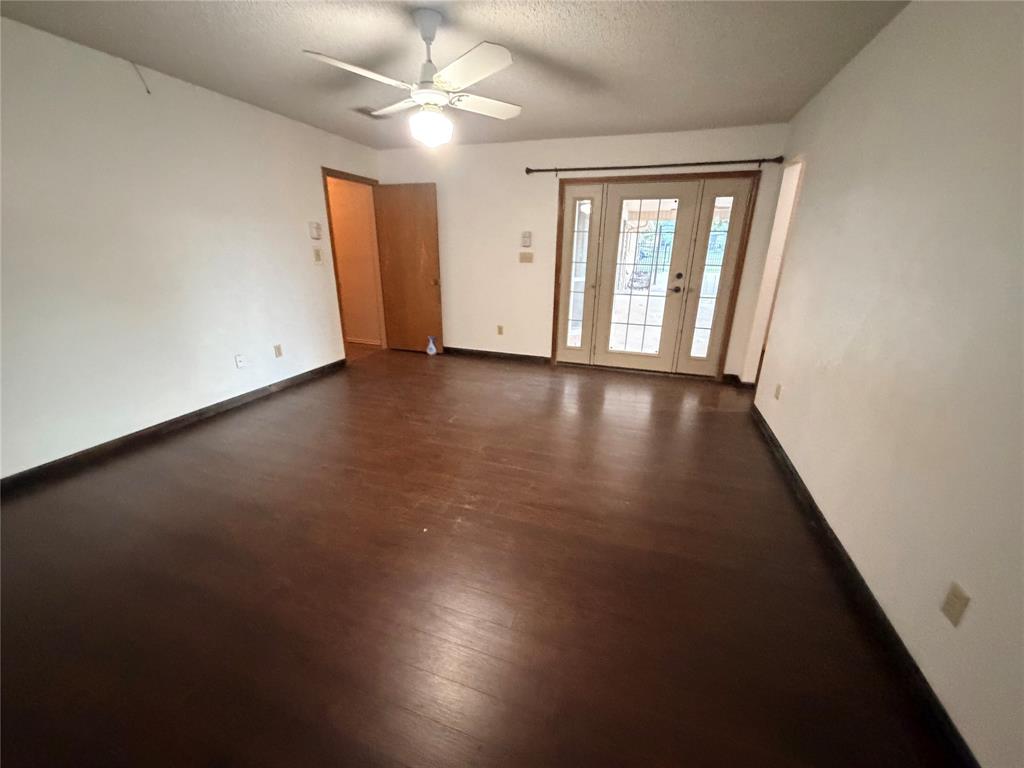 3472 North Masch Branch Road Denton, TX 76249 - Photo 2 of 17 an empty room with wooden floor and windows
