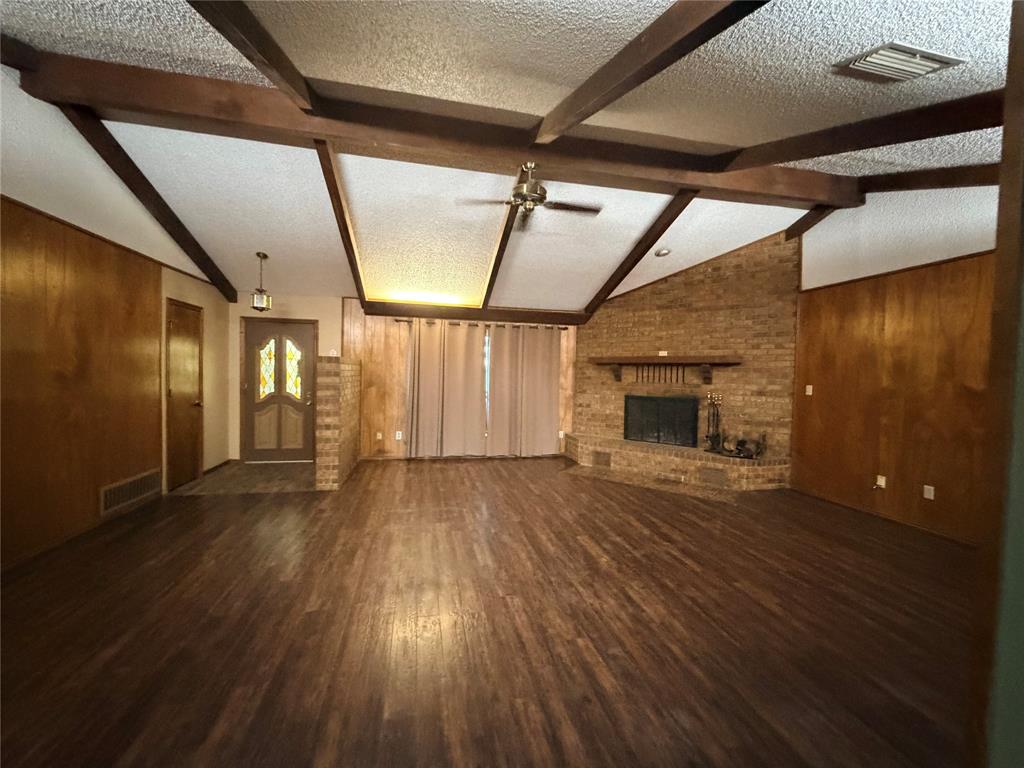 3472 North Masch Branch Road Denton, TX 76249 - Photo 5 of 17 a view of empty room with wooden floor and fireplace