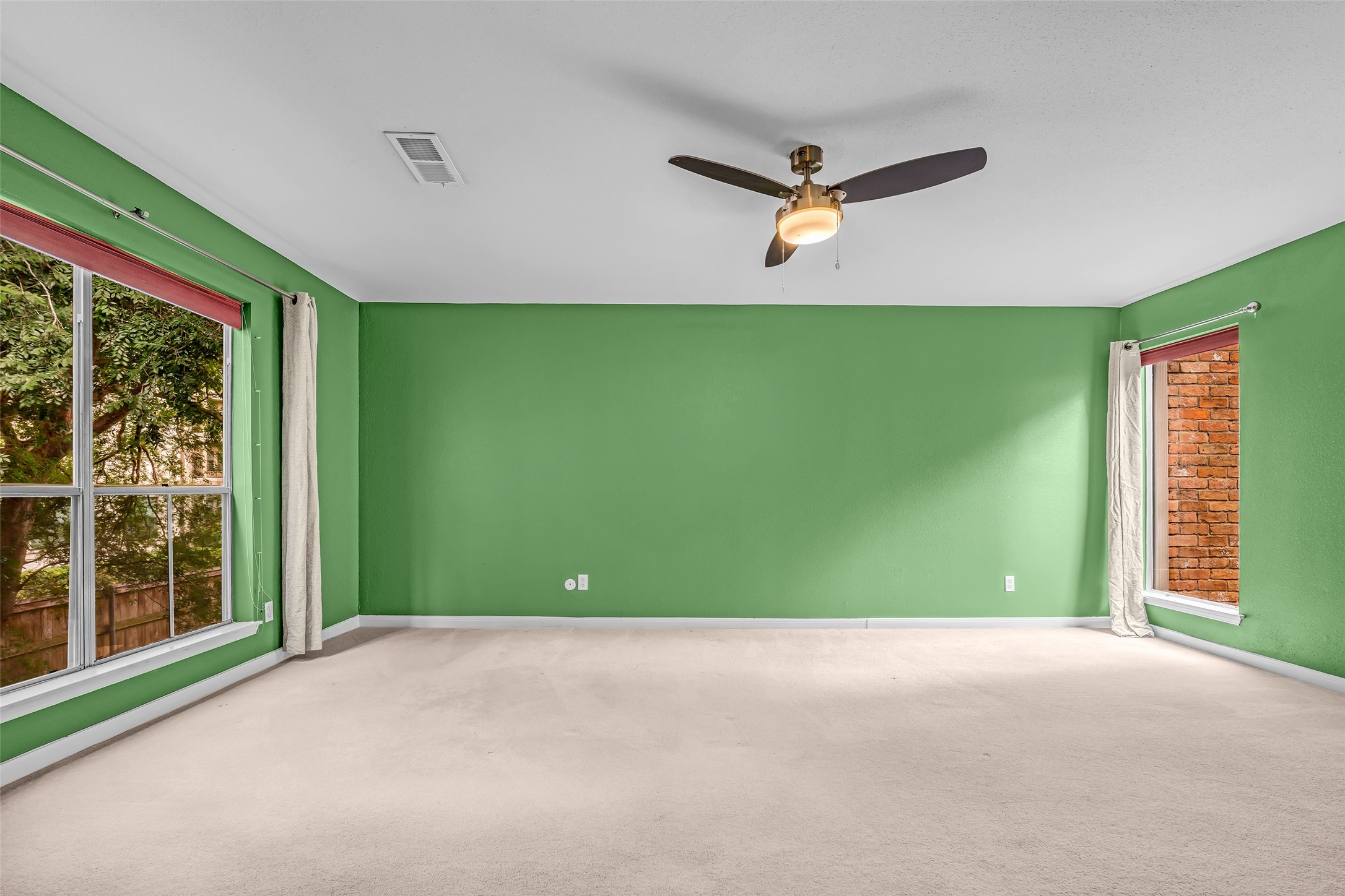 7485 Brompton Street, Unit 7485 Houston, TX 77025 - Photo 25 of 43 Generous primary retreat overlooking the tranquil atrium, creating a peaceful and inviting atmosphere. Offering two closets for ample storage and organization, this private sanctuary offers both comfort and functionality.