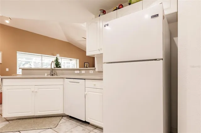 a white refrigerator freezer sitting inside of a kitchen