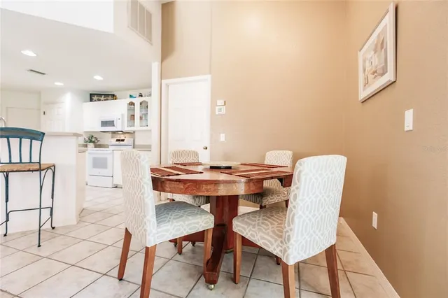 a view of a dining room with furniture and a chandelier