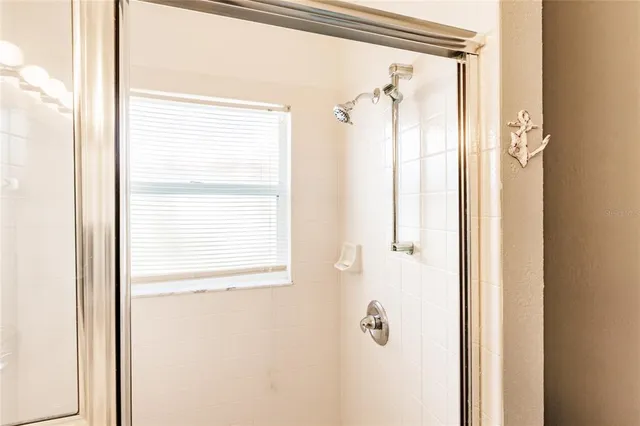 a bathroom with a shower and a door