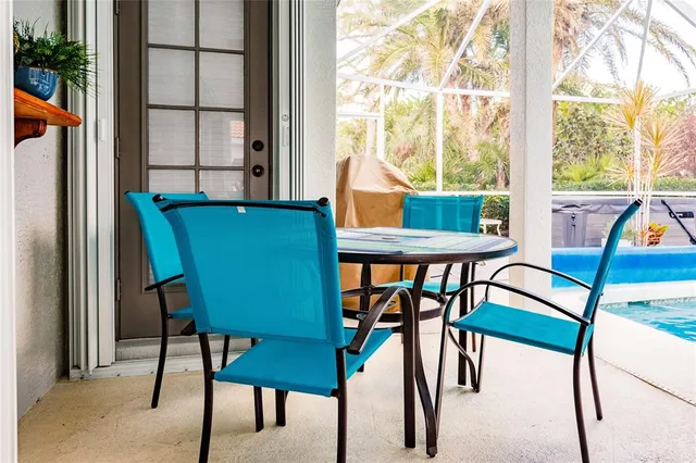a view of a chairs and table in the balcony