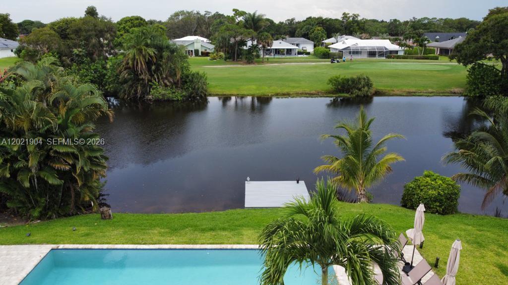 3324 Lakeview Boulevard Delray Beach, FL 33445 - Photo 30 of 36 a view of a lake with a yard and large trees
