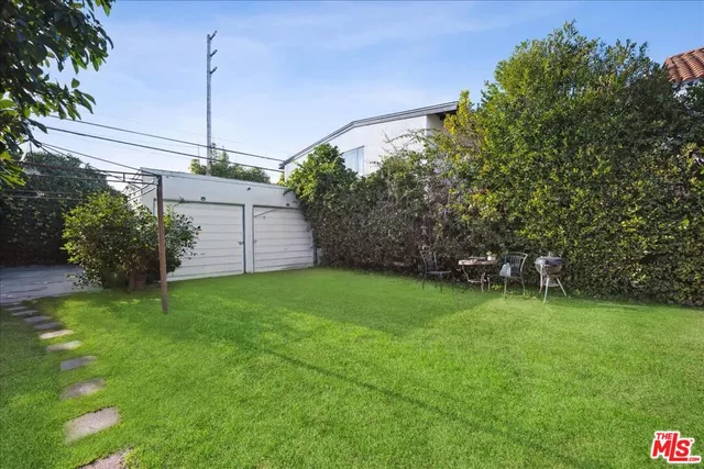 a view of a backyard with potted plants