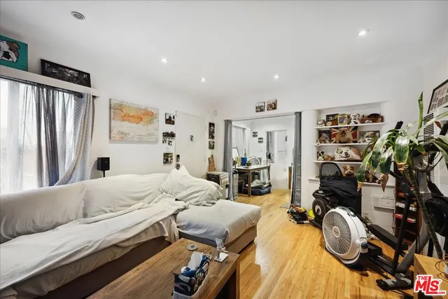 a bedroom with furniture and a flat tv screen