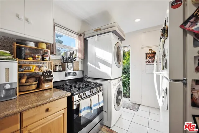 a kitchen with stainless steel appliances a stove a sink and a refrigerator