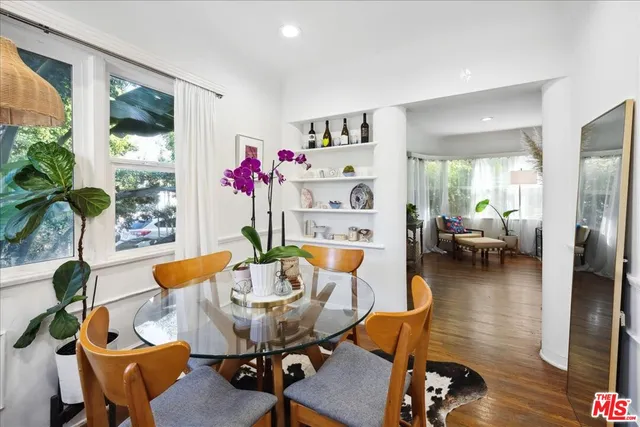 a view of a dining room with furniture and a potted plant