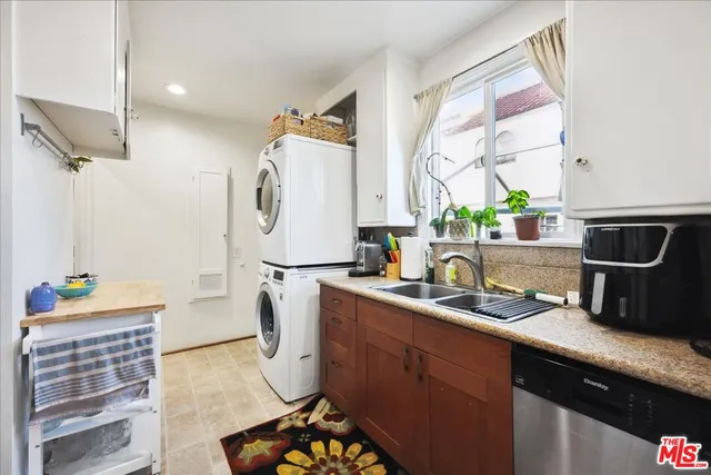 a kitchen with a sink cabinets and window