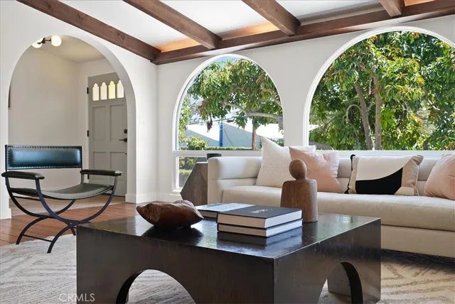 a living room with patio furniture and a large window