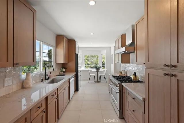 a kitchen with sink stove and cabinets