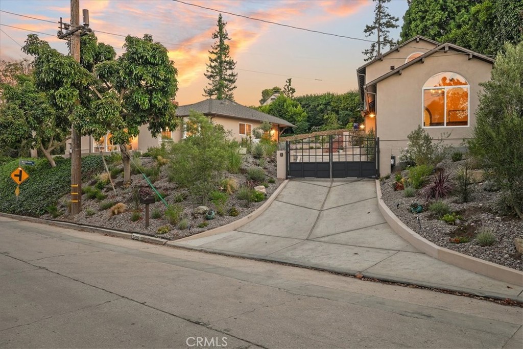 7404 Woodrow Wilson Drive Los Angeles, CA 90046 - Photo 2 of 57 a front view of a house with a yard and potted plants