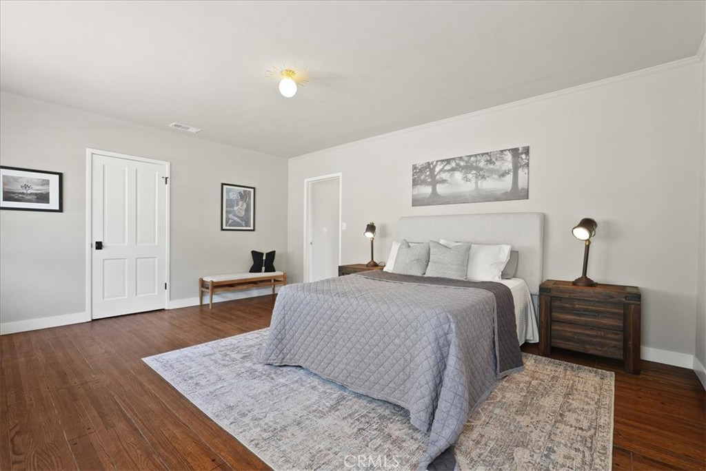 7404 Woodrow Wilson Drive Los Angeles, CA 90046 - Photo 23 of 57 a spacious bedroom with a bed and wooden floor