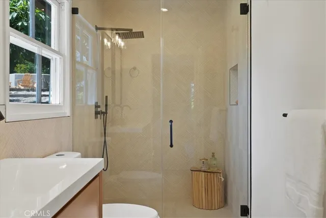 a spacious bedroom with a bed and a chandelier