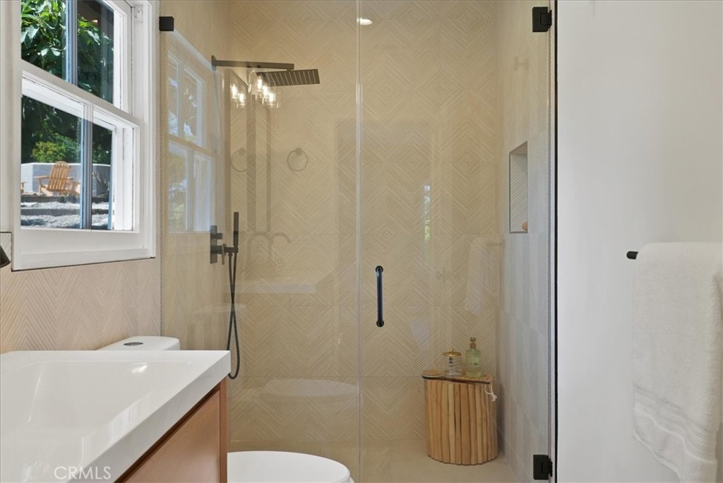 7404 Woodrow Wilson Drive Los Angeles, CA 90046 - Photo 25 of 57 a bathroom with a granite countertop bathtub shower sink and toilet