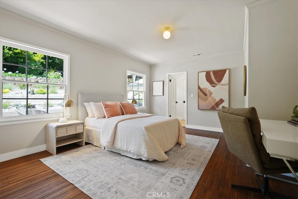7404 Woodrow Wilson Drive Los Angeles, CA 90046 - Photo 26 of 57 a bedroom with a bed and wooden floor